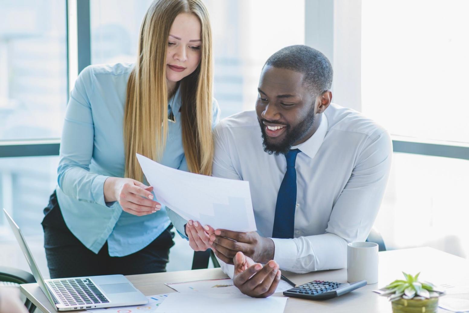 Financial planning consultation with business owner reviewing documents
